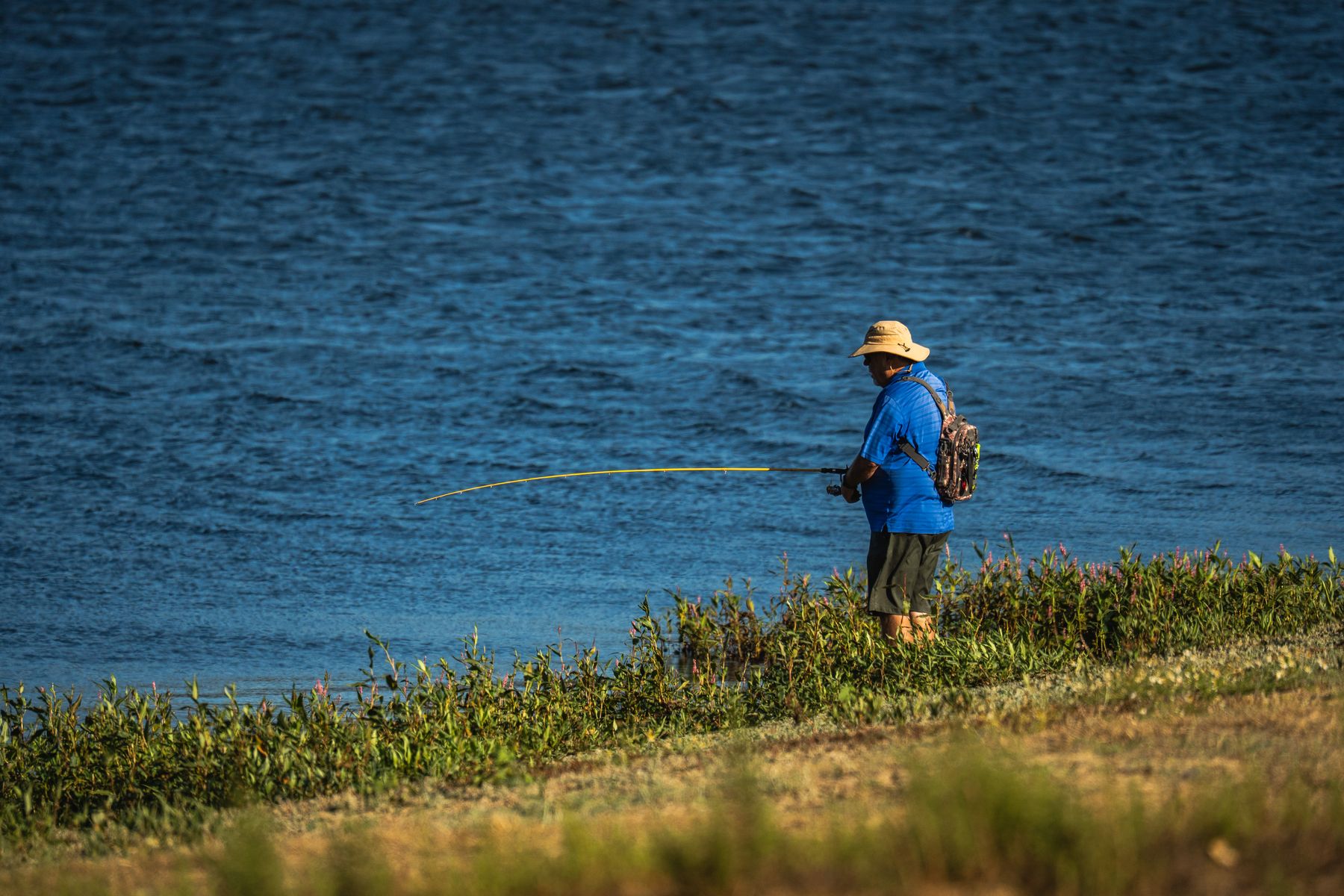 An angler enjoying a quiet day by the water