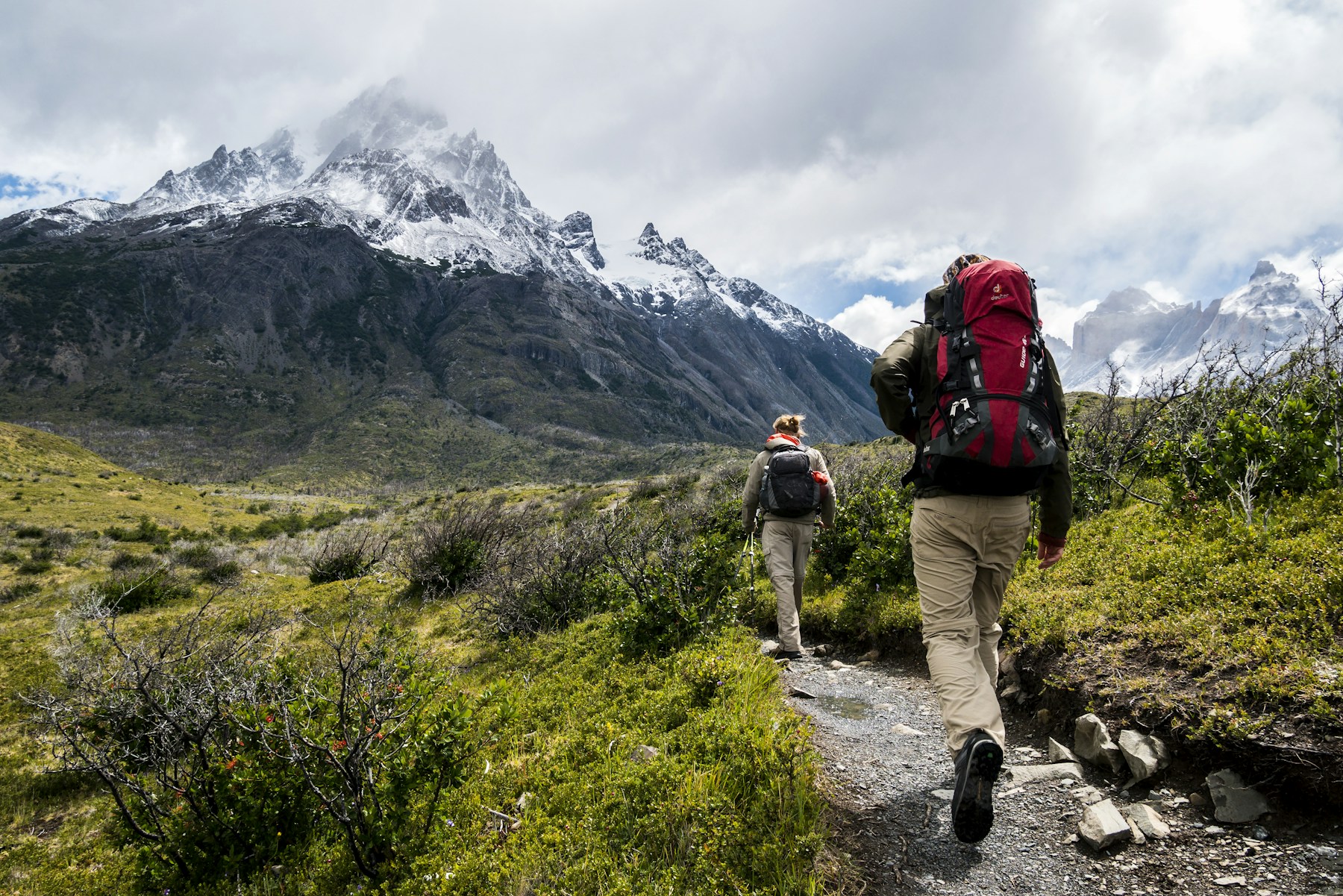 People enjoying a walk along a scenic mountain trail